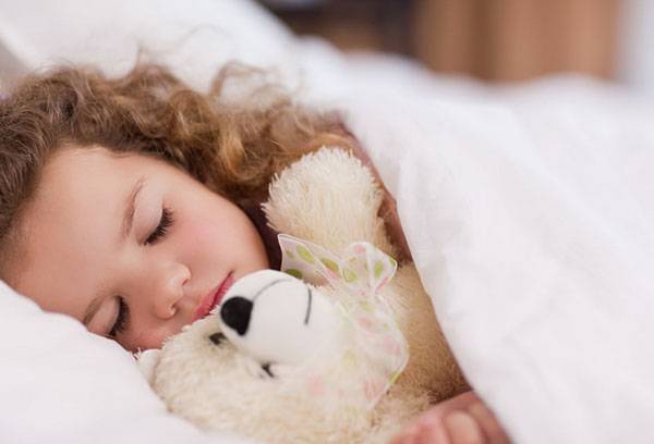 Girl sleeping with a toy