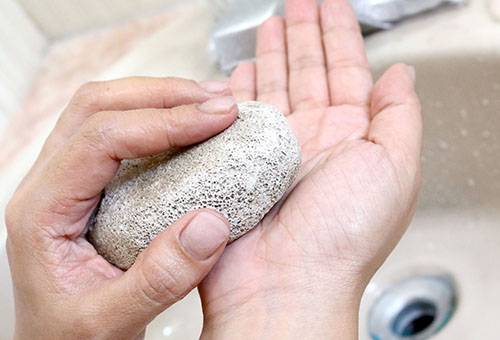 Hand glue scrubbing with pumice stone