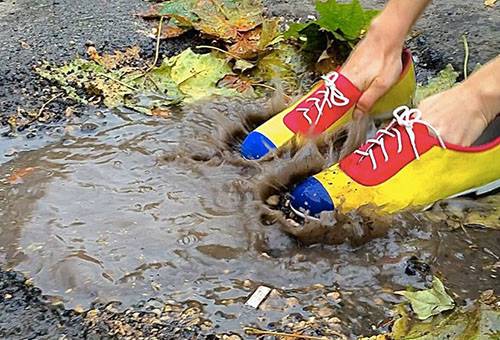 Suede shoes in a puddle