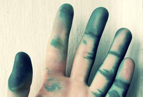 stained hand in green