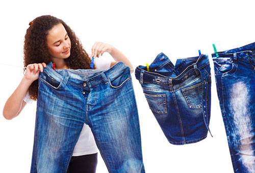 Girl menggantung seluar jeans untuk pengeringan