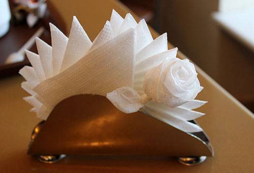 Beautifully folded napkins in a napkin holder