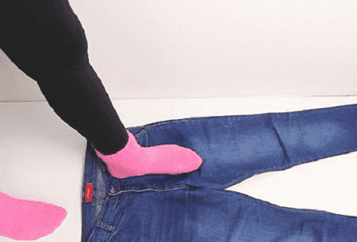girl stands on jeans