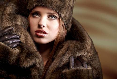 Girl in a fur coat and hat made of mink fur
