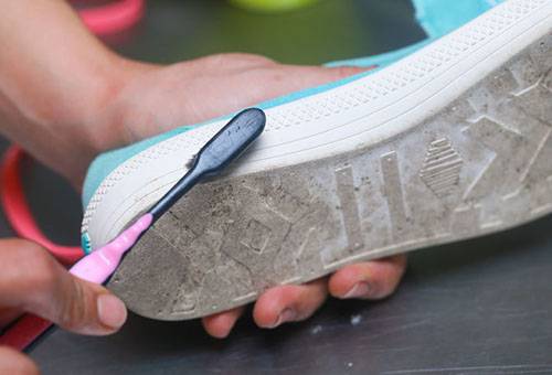 Cleaning the white sole of a sneaker