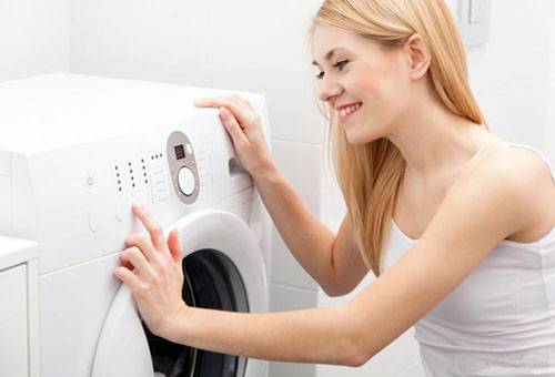 Girl turns off the washing machine