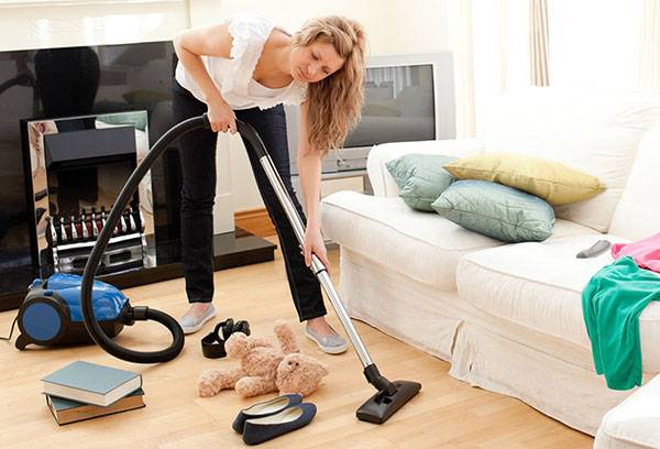 Girl vacuuming in the living room