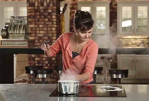 Girl cooks on a glass ceramic stove