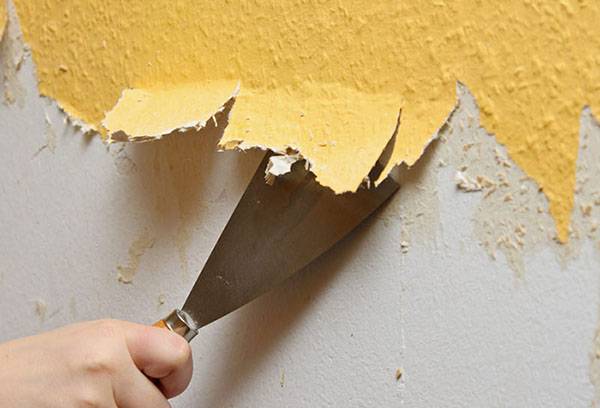 Removing old wallpaper with a spatula