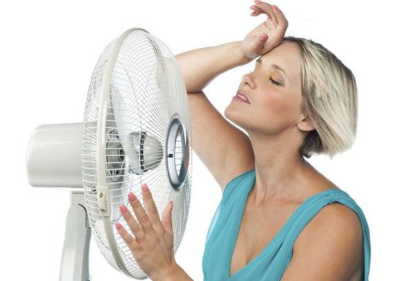 Girl sitting in front of a fan