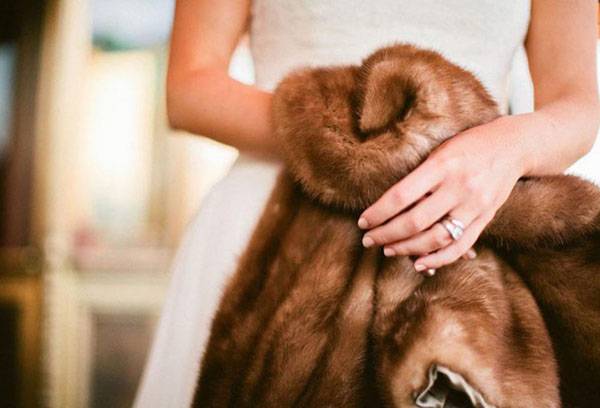 Girl holds a fur coat