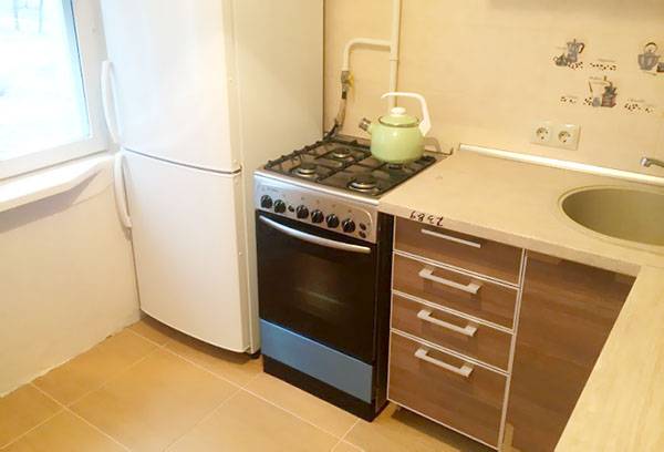 A stove next to the refrigerator