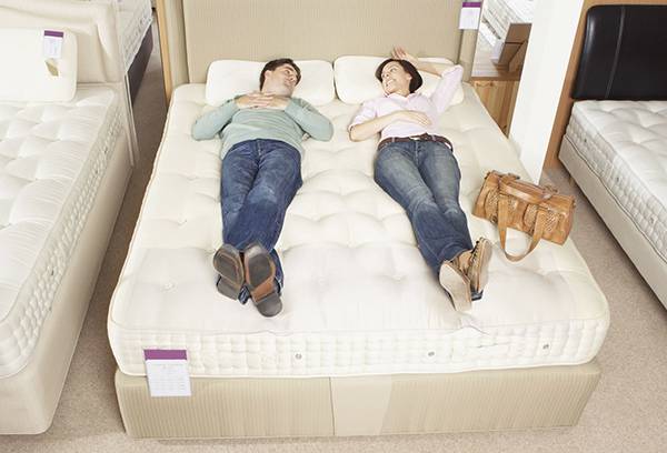 Couple chooses a mattress in a store