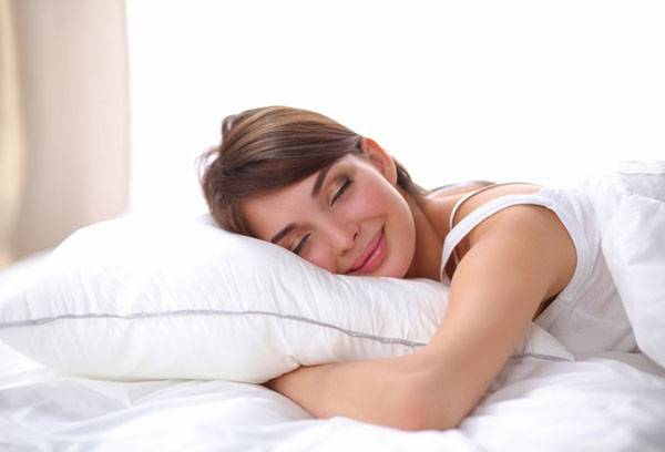 Girl sleeping on a feather pillow