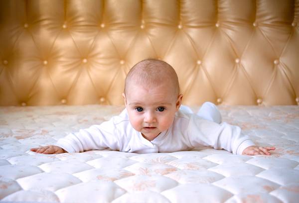 Baby on the big bed