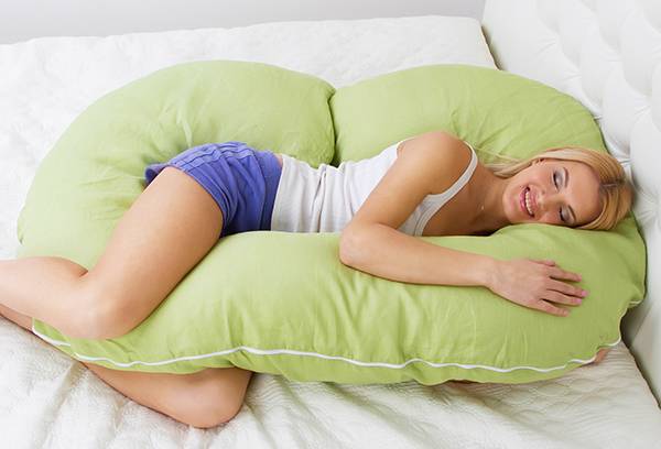 Woman with a pillow for pregnant