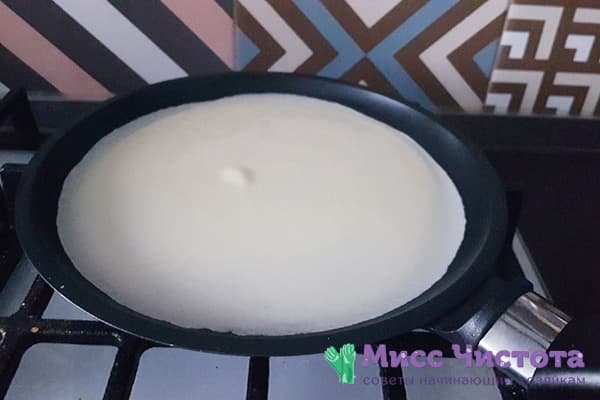 Thin pancake dough in a pan