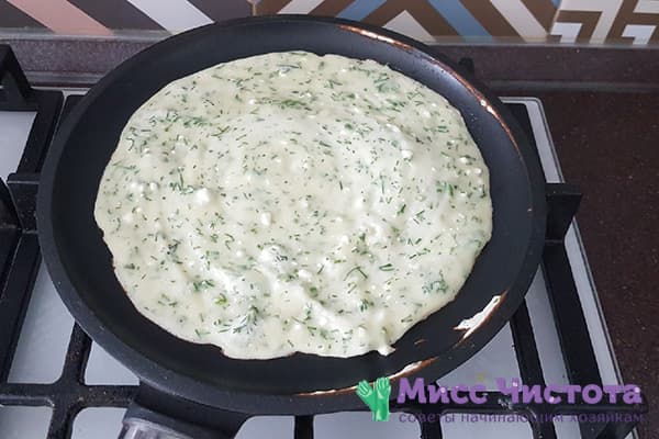 Dough with cheese and herbs in a pan