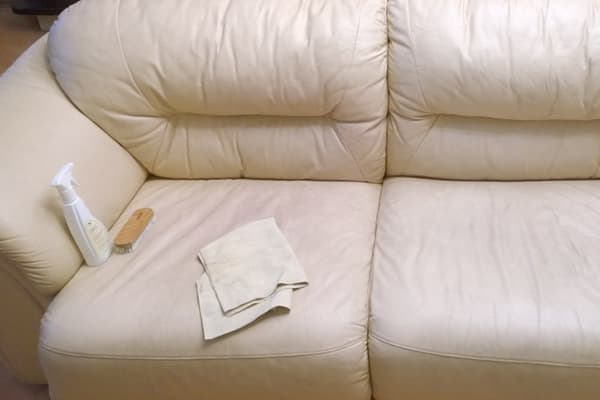 Cleaning a bright leatherette sofa