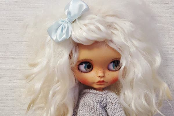 Doll with artificial hair