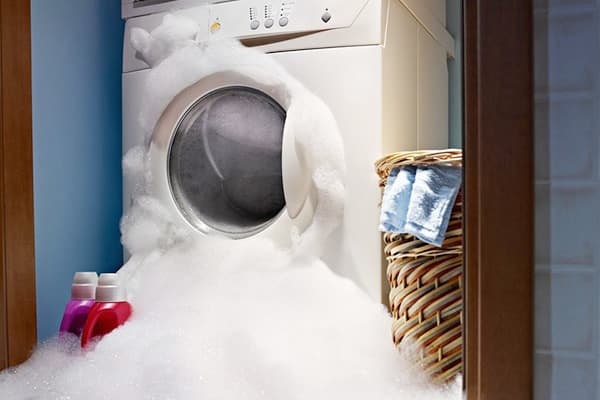Foam climbs out of the washing machine