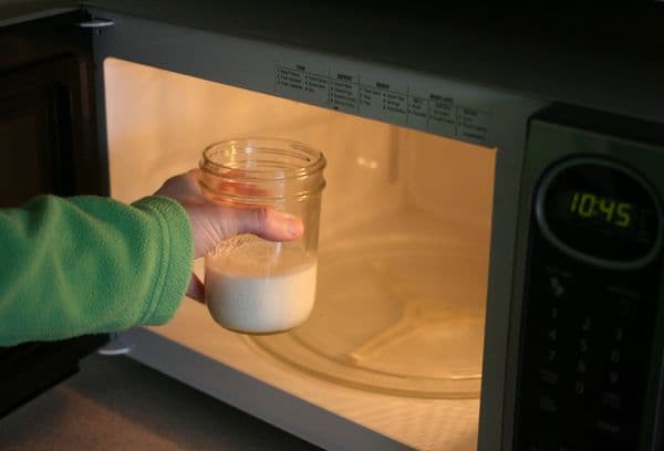 A glass of milk in the microwave