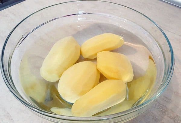 peeled potatoes in water