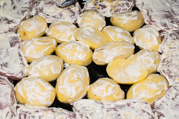 Potatoes and meat in mayonnaise before baking
