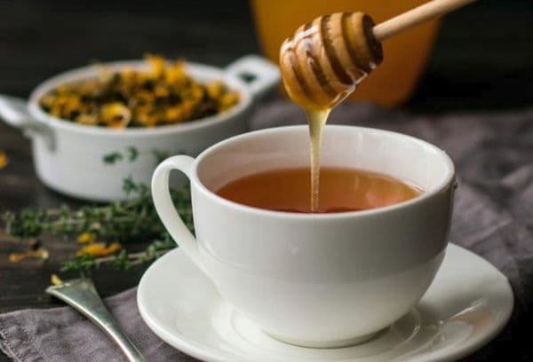 Adding honey to hot tea