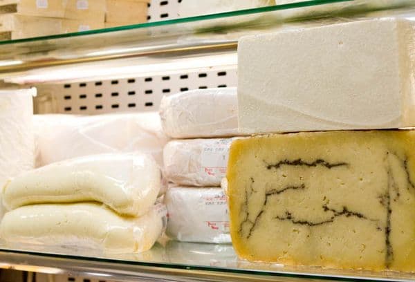 Cheeses of different varieties in the refrigerator