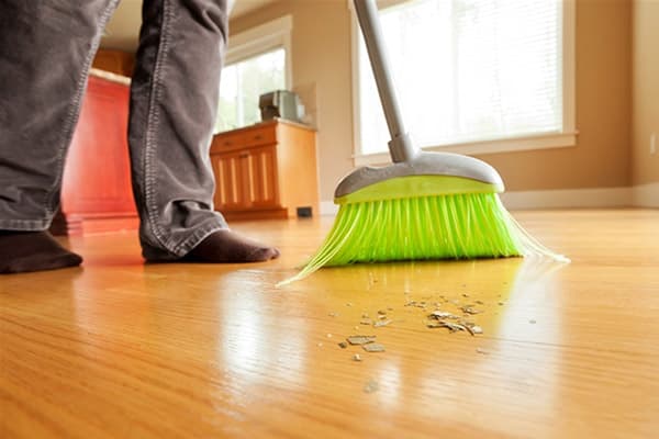 A man sweeping the floor